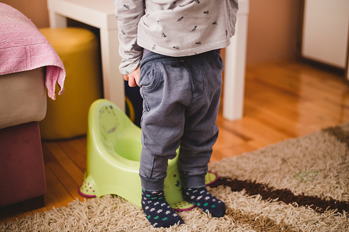 Child preparing to sit on the potty