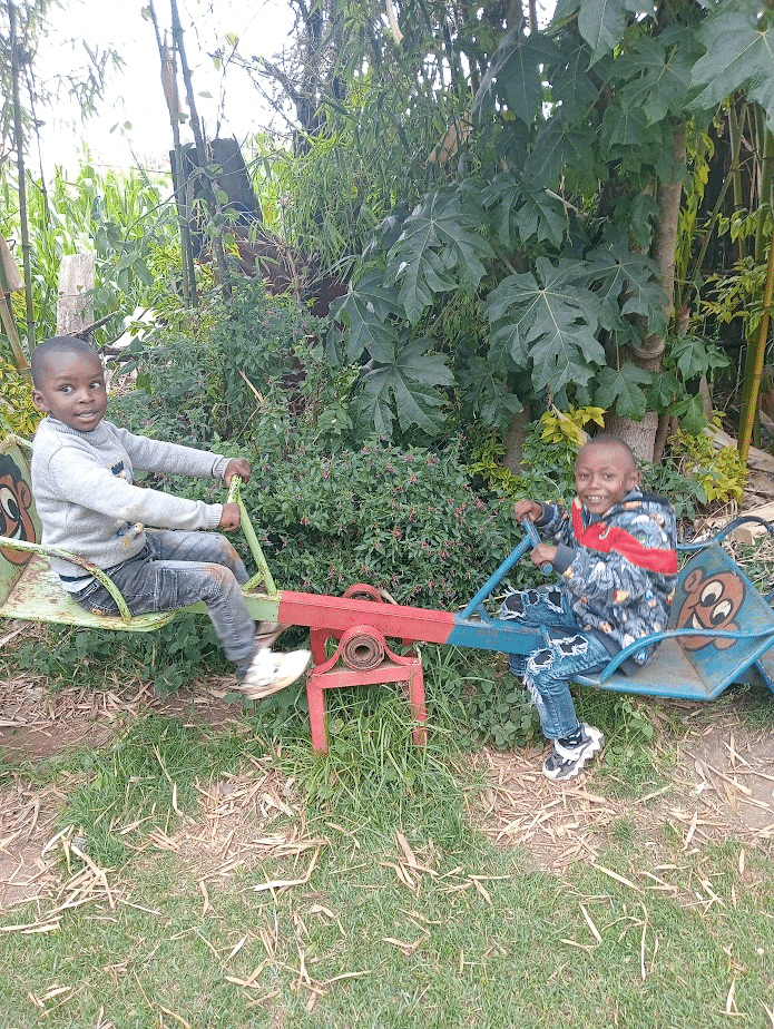 my son and a friend on a see-saw